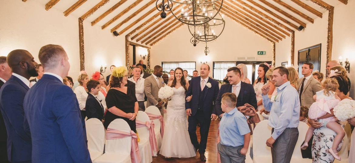 Bride and father walking on the aisle