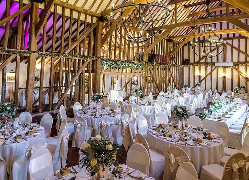 White ribbons tied on wedding chairs