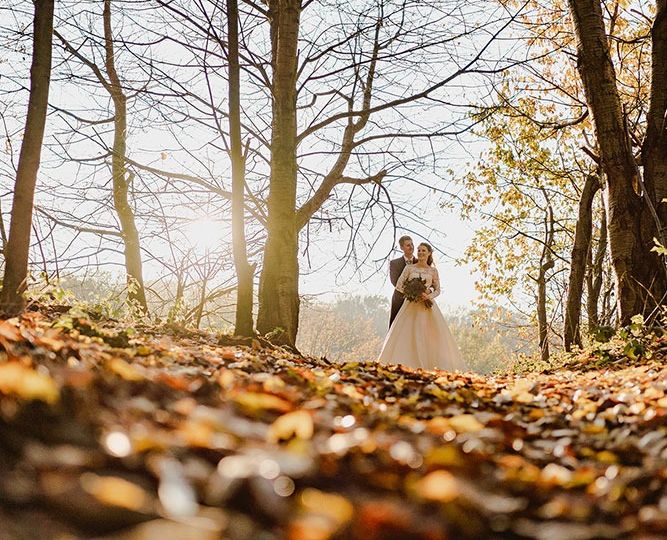Happy bride and groom in autumn outdoors