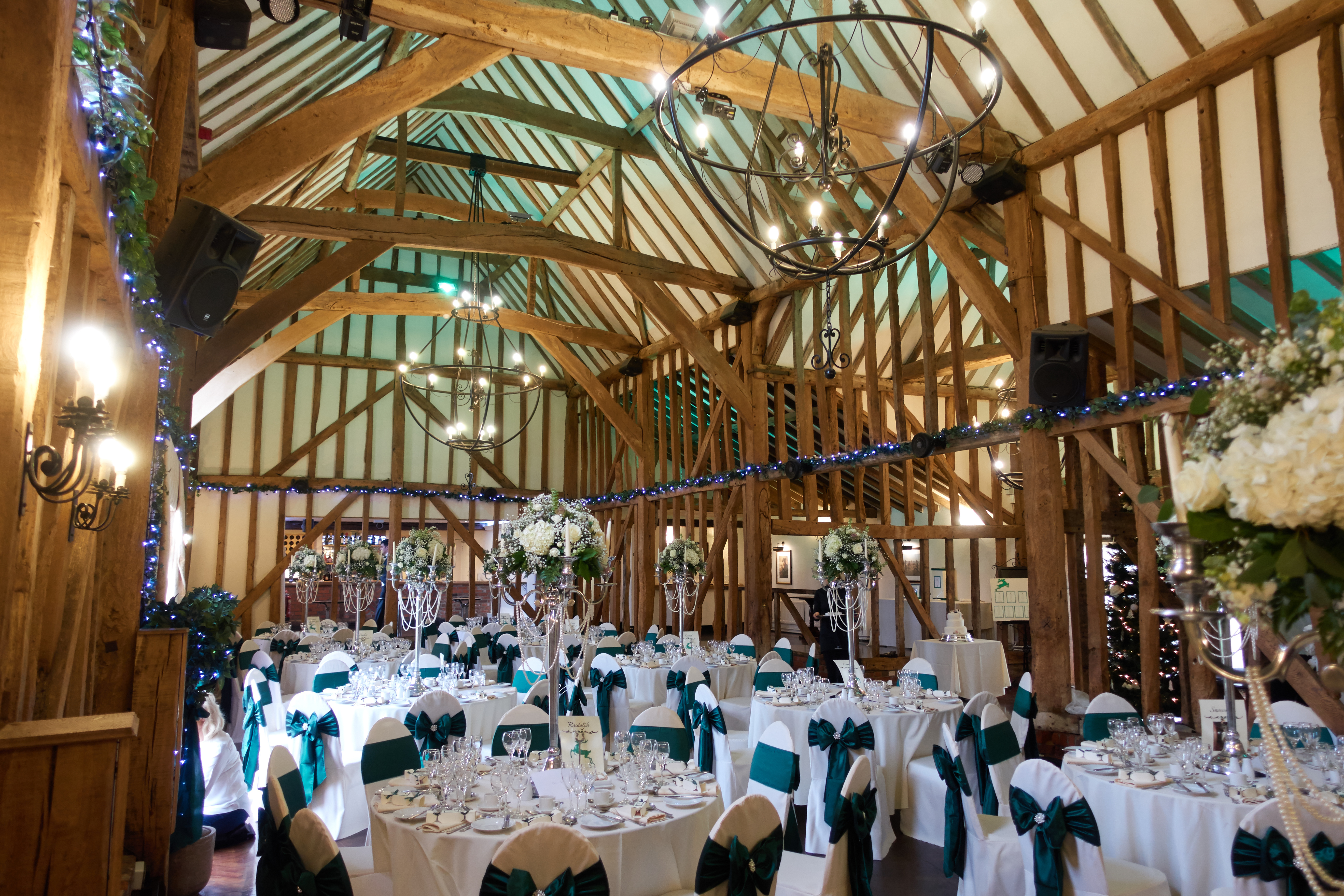 Teal coloured seat bows in a wedding hall