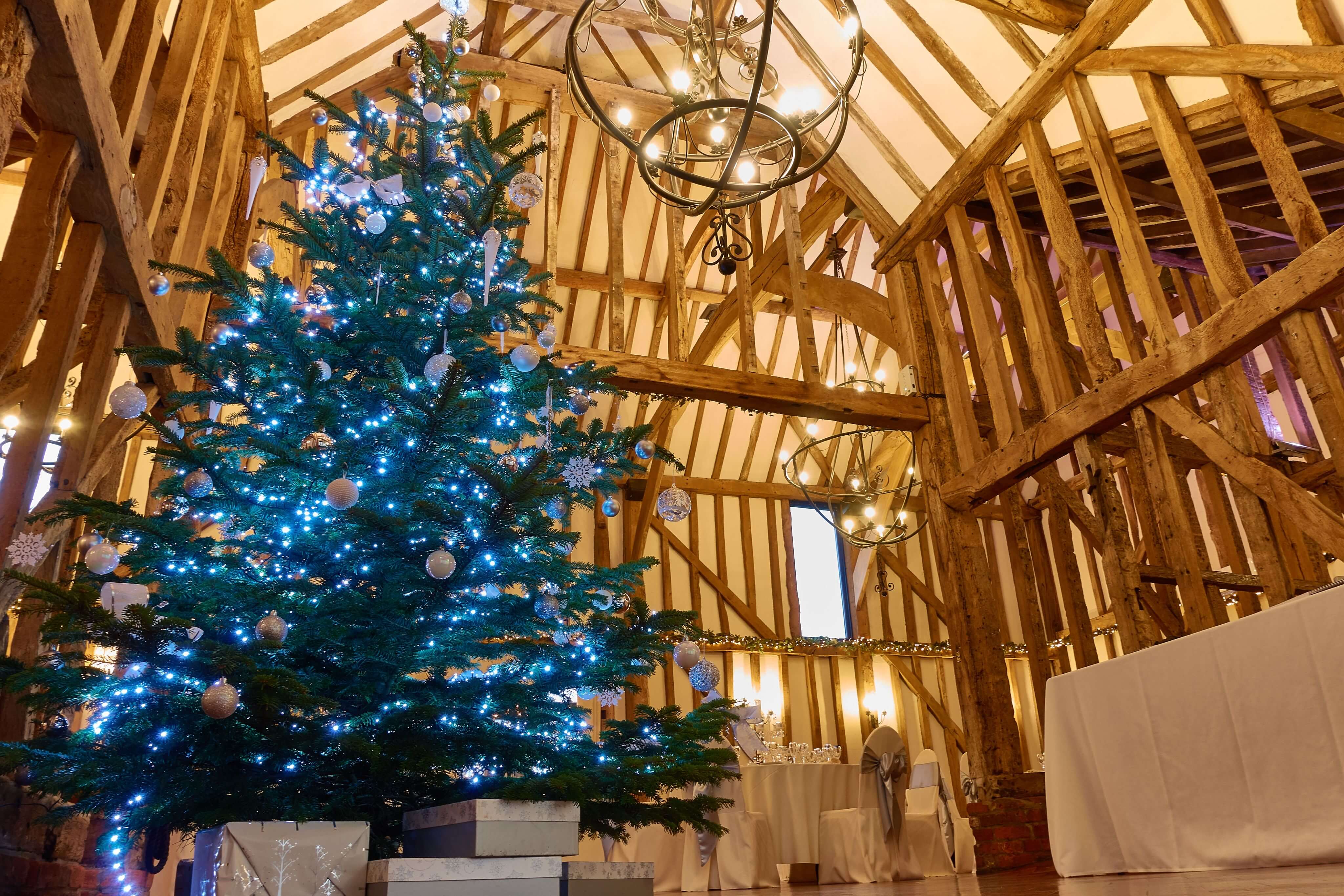 Christmas Tree with white ornaments and blue lights in a venue